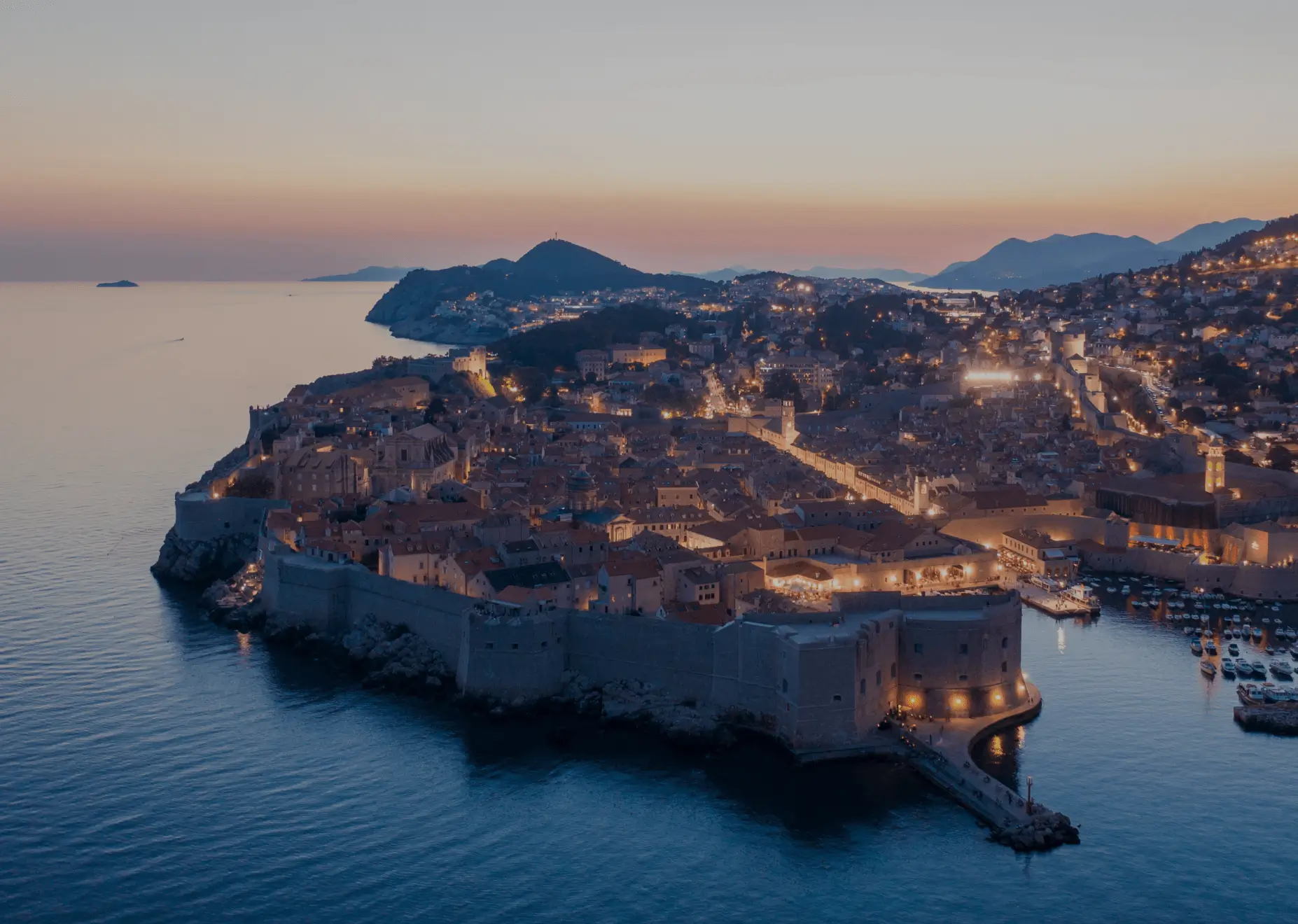 Sailing yacht sailing near the famous city walls of Dubrovnik, a top destination for sailing in Croatia
